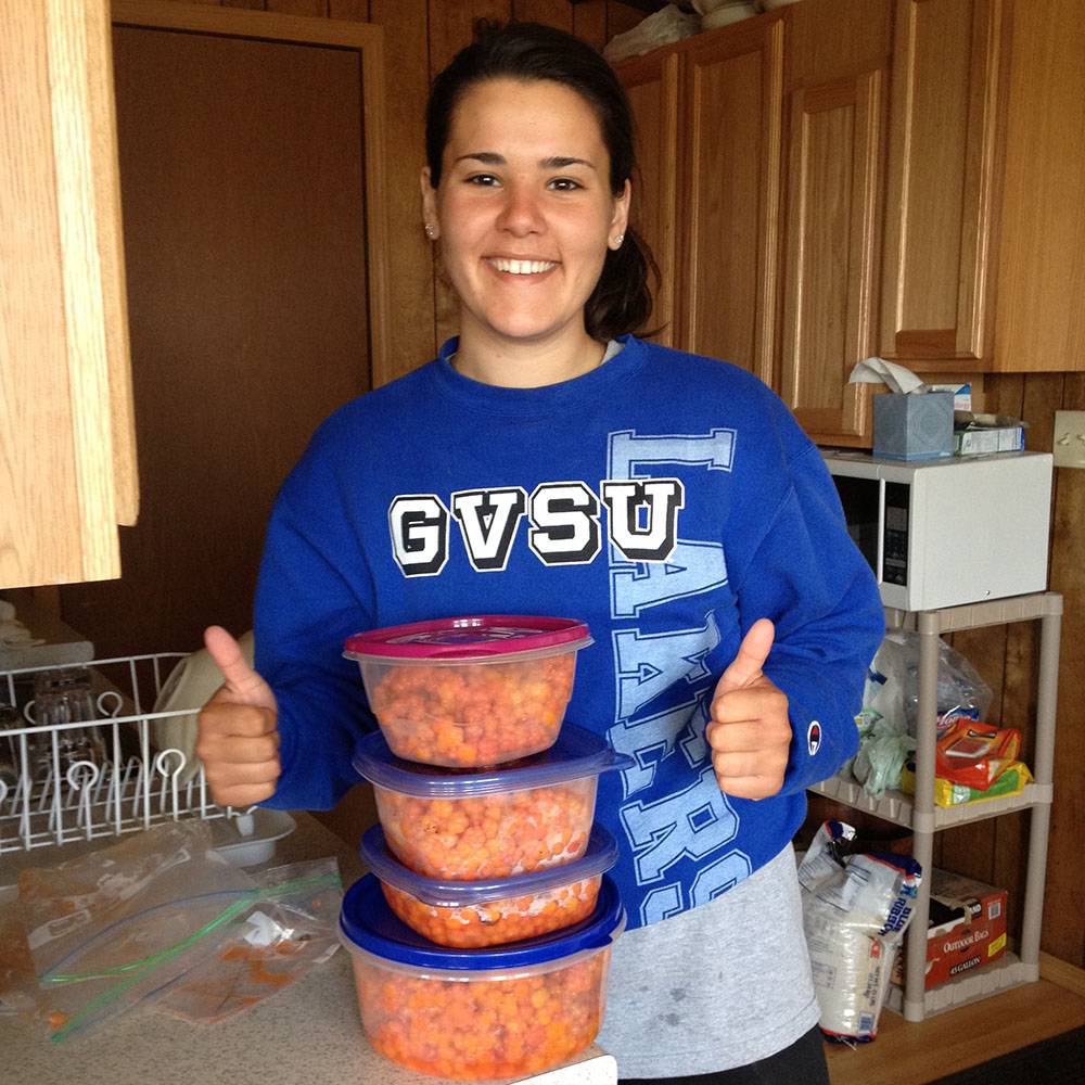 She smiles with several containers of salmonberries.